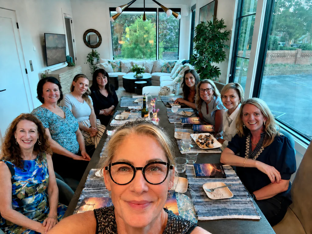 Eight women seated around a dinner table in a private home in Greenville